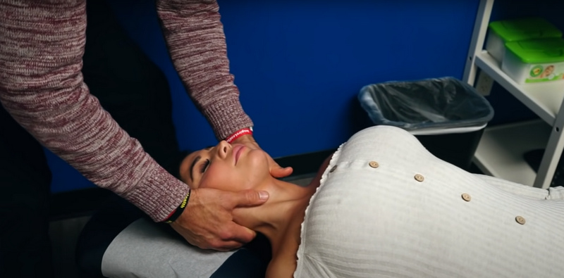 The moment of the video where a beautiful girl in chiropractor room